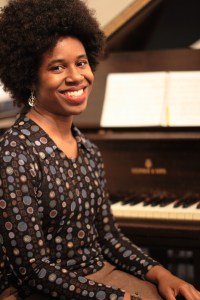 sitting at piano with notebook